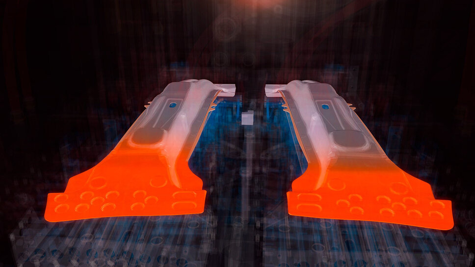 Illustration: Two B-pillars, inserted and formed in a hot forming tool. Transparent cooling of the tool. The SoftZone areas (Tailor Tempering) of the B-pillar are marked in orange