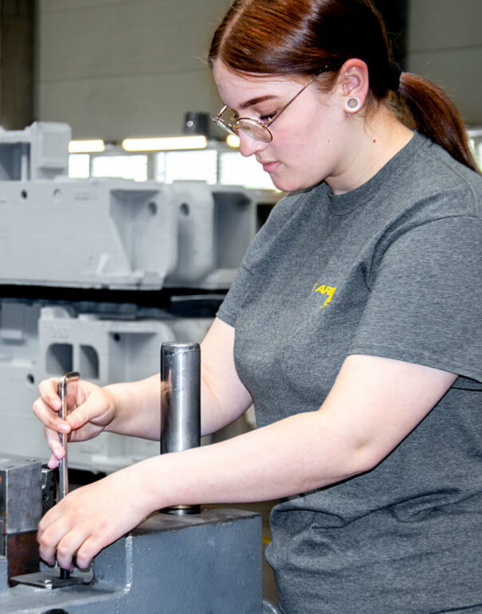 A young toolmaking technician is assembling stamping tools during her apprenticeship at weba Werkzeugbau in Steyr.